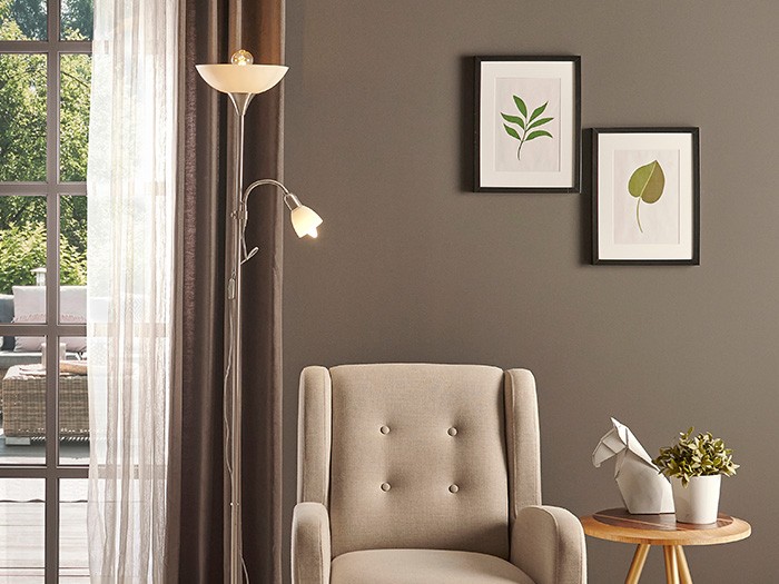 accent chair next to torchiere tree floor lamp